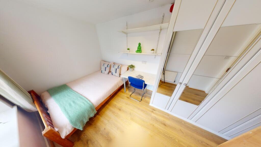 A bright and tidy double bedroom featuring a co...
