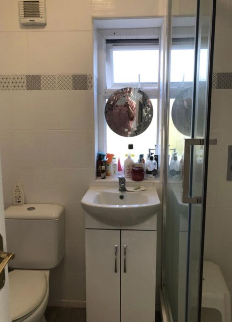 A bright and tidy bathroom featuring a modern s...