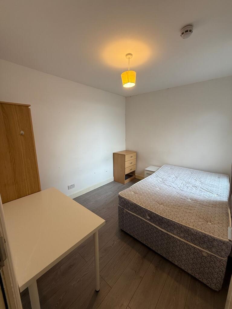 A simple and functional double bedroom featurin...