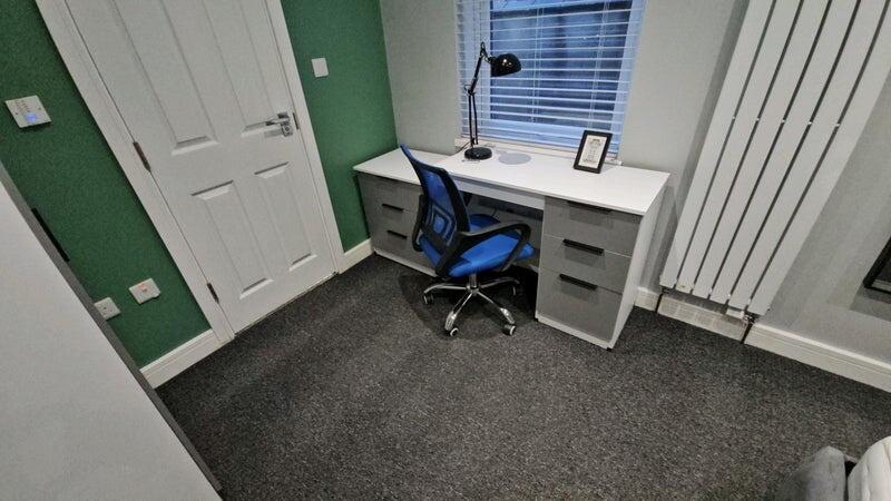 A neat and modern communal workspace featuring ...