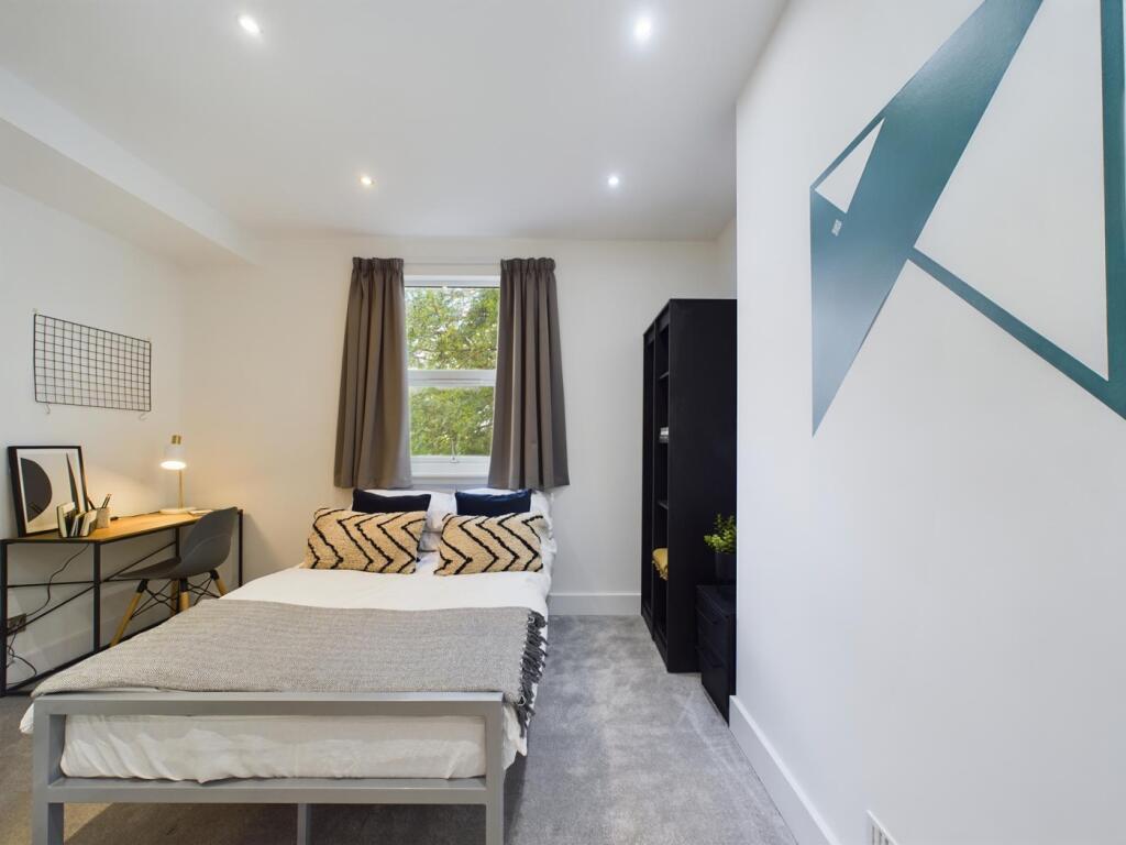 A bright and inviting double bedroom featuring ...