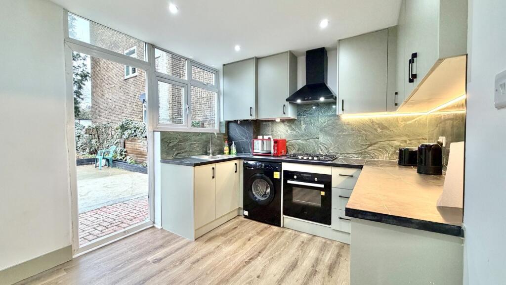 Modern fitted kitchen with integrated appliance...