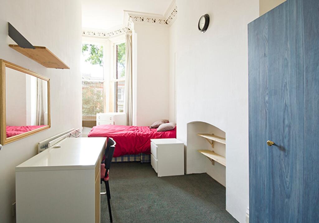 A bright and inviting double bedroom featuring ...