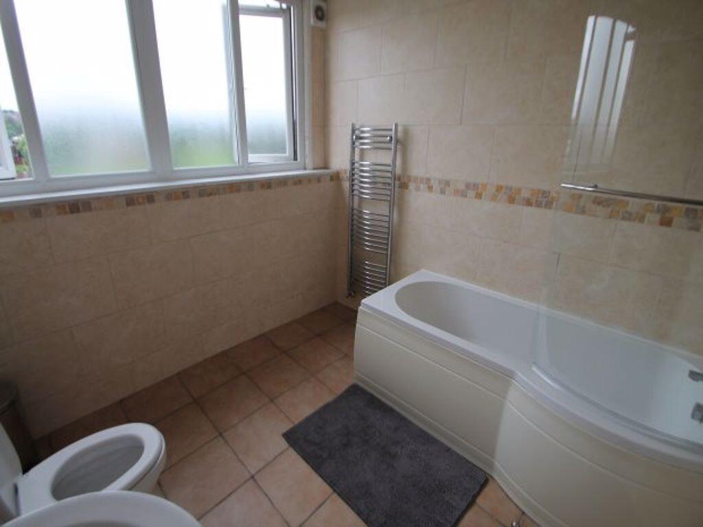 A bright and clean bathroom featuring a spaciou...