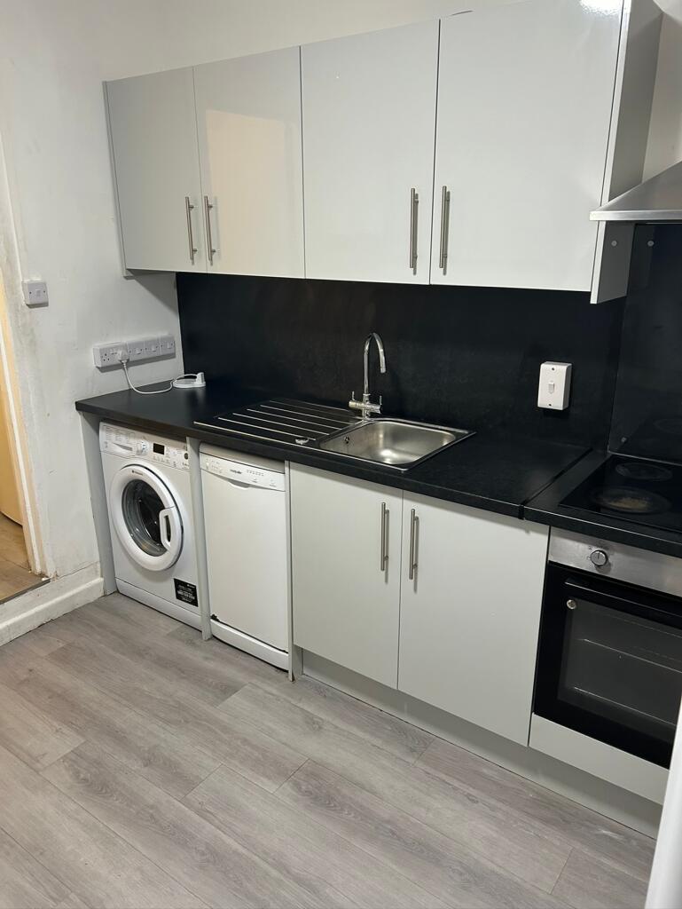 A modern and tidy kitchen featuring essential a...