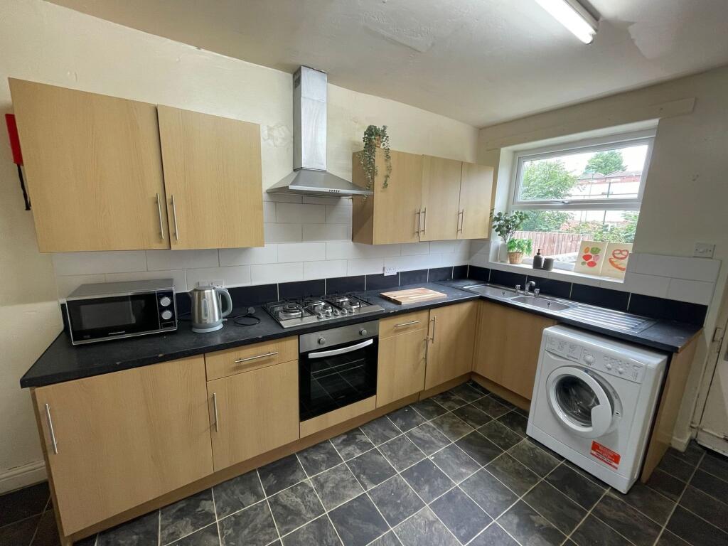 A modern, well-maintained kitchen featuring woo...