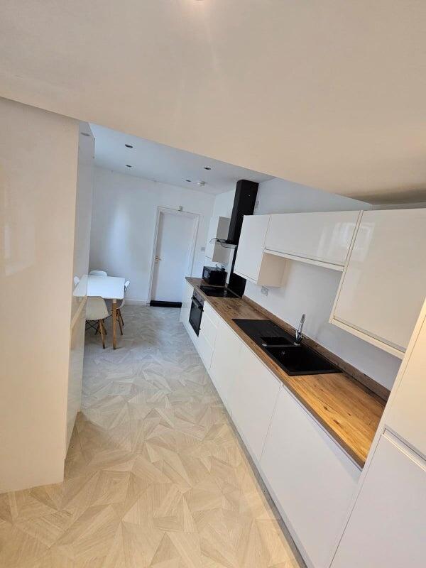 Bright and modern kitchen featuring sleek white...