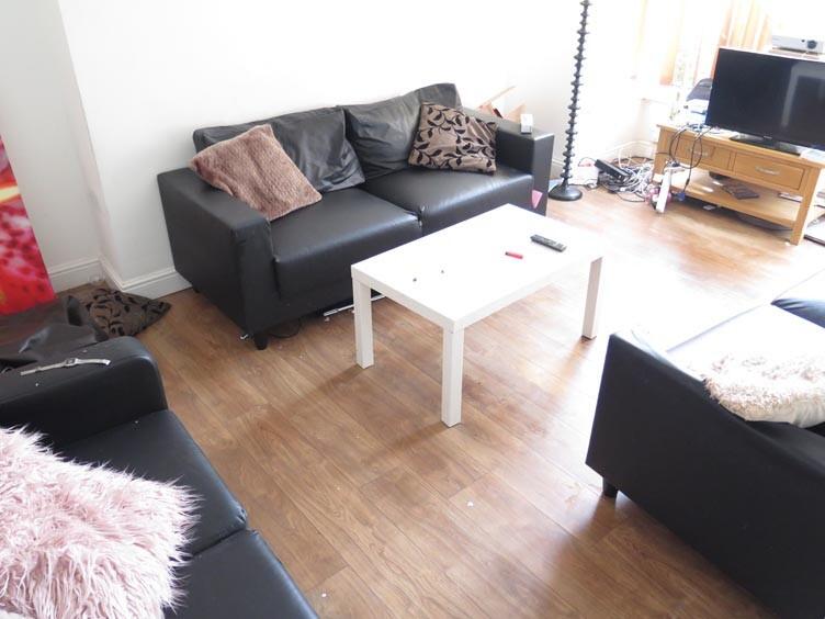 A bright and welcoming living room featuring co...
