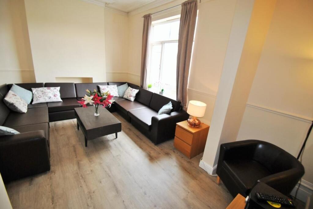 Bright, modern living room with a large L-shape...