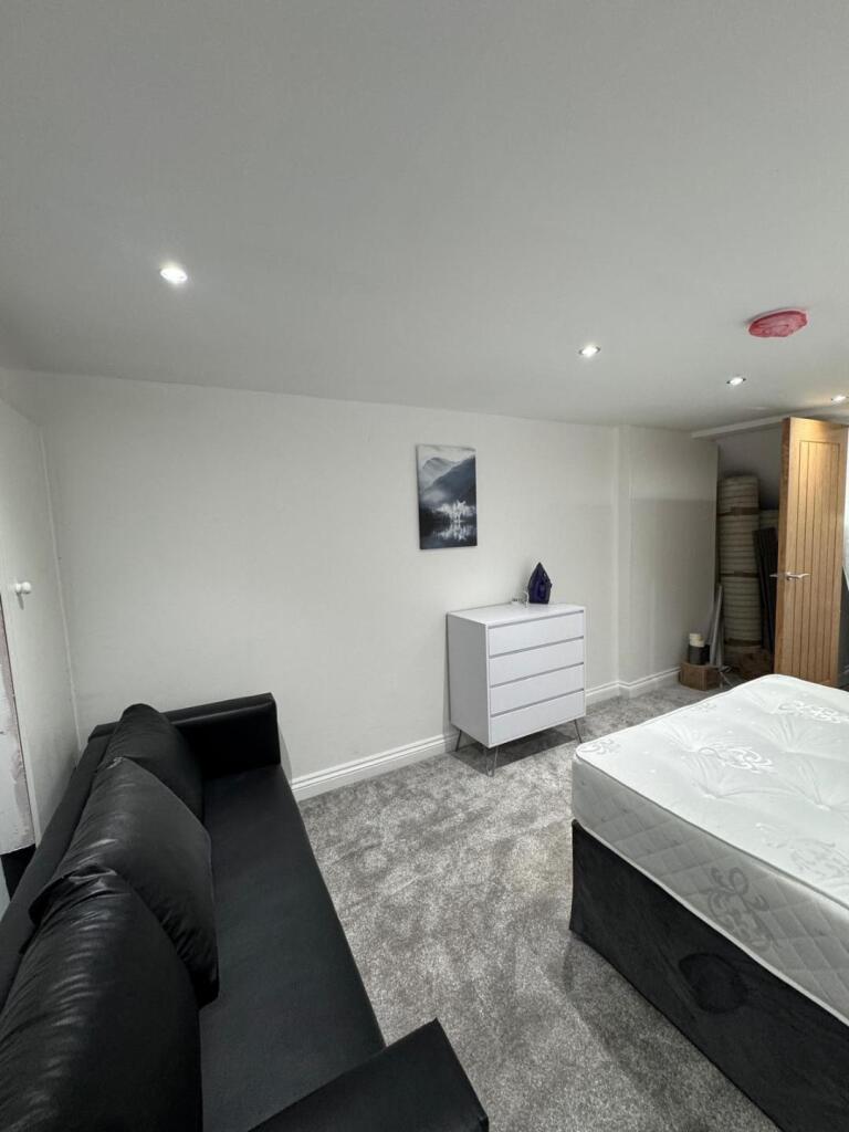 A clean and modern double bedroom featuring a c...