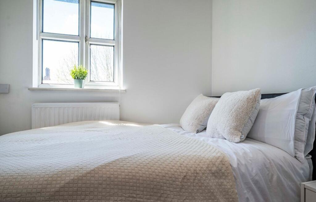 A bright and inviting double bedroom featuring ...