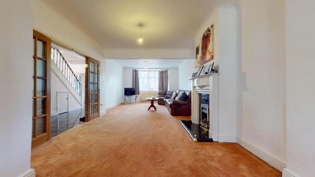 Spacious living room with warm carpeting and a ...
