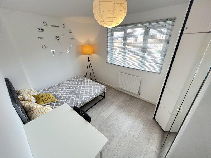 A bright and tidy double bedroom featuring a co...