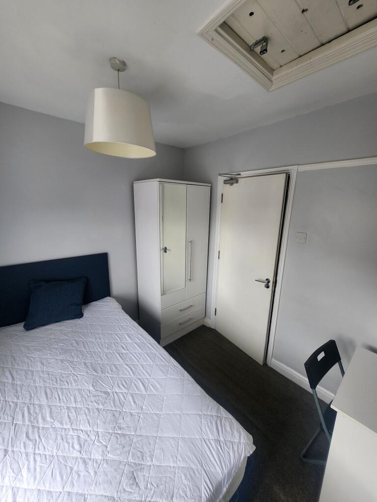 Bright and tidy double bedroom featuring a comf...