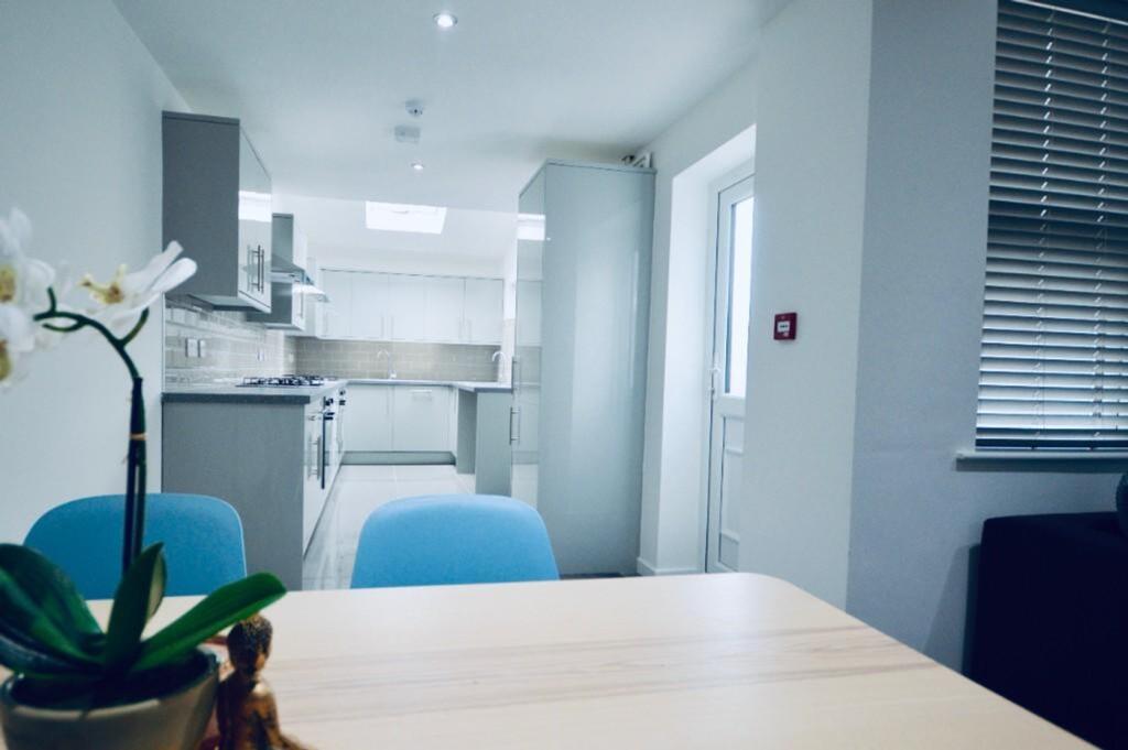 A modern and spacious kitchen with ample natura...