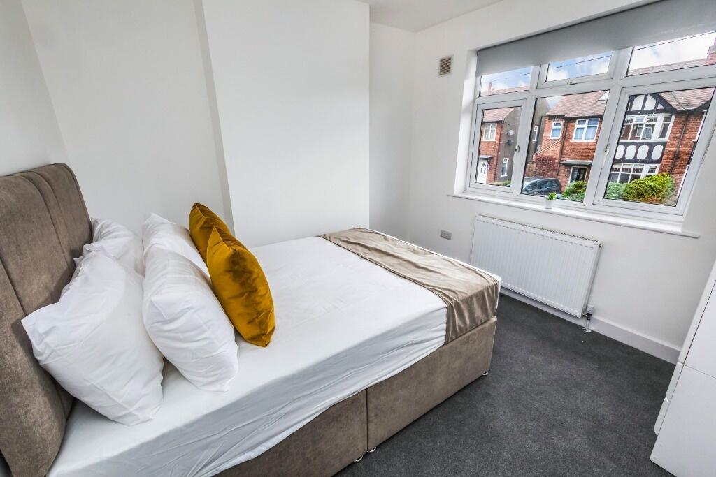 Bright and cozy double bedroom featuring a comf...