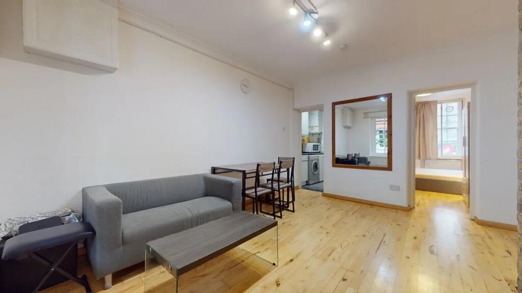 A bright and tidy living room featuring a moder...