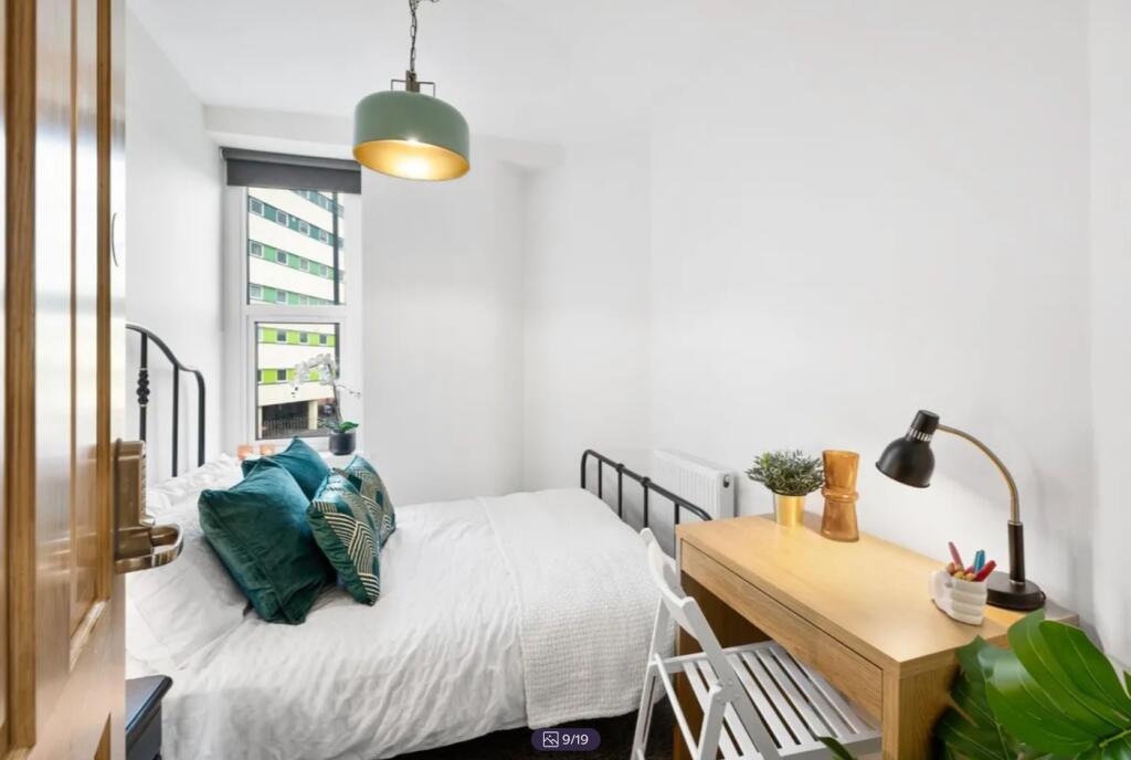 A bright and inviting double bedroom featuring ...