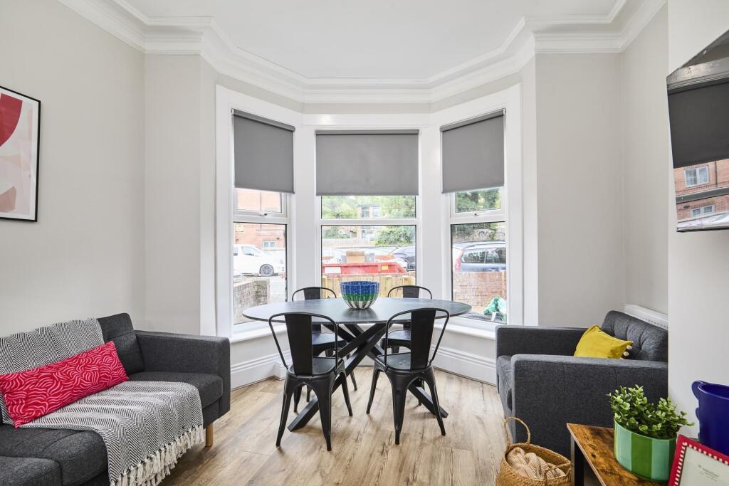 Bright and welcoming living room featuring ampl...