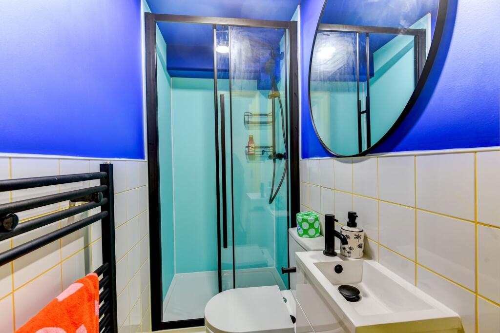 Modern bathroom featuring a sleek shower enclos...