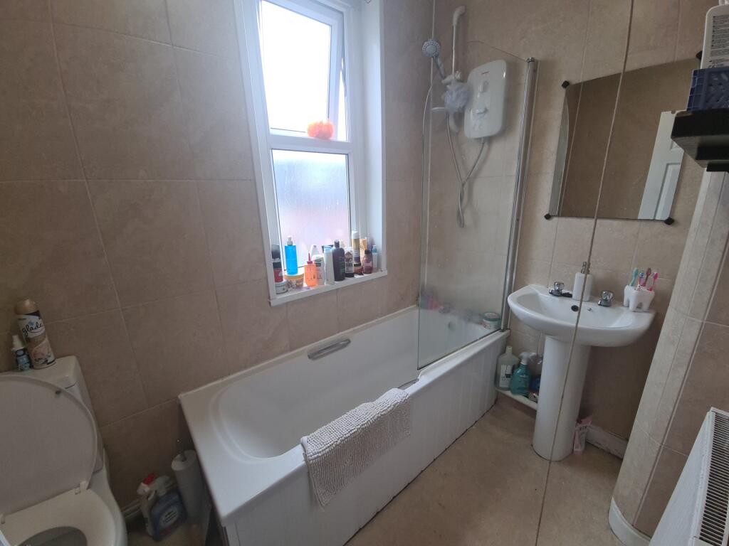 Bright and clean bathroom featuring a full-size...