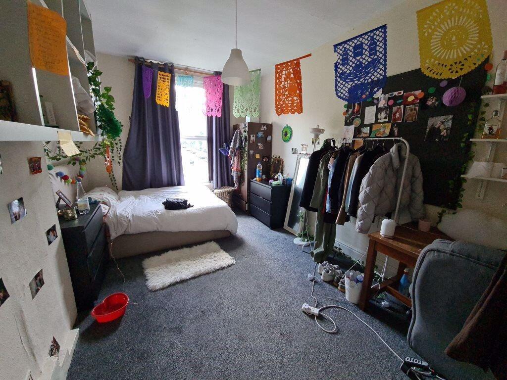 A cozy and inviting master bedroom featuring a ...