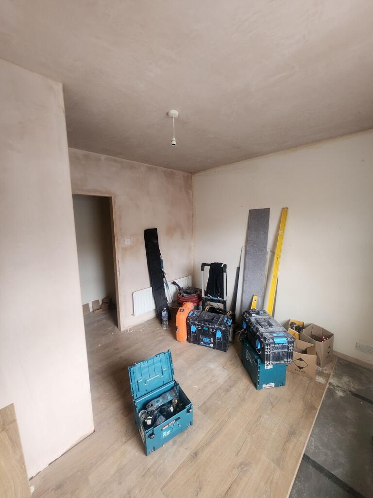 A room under renovation with wood-effect floori...