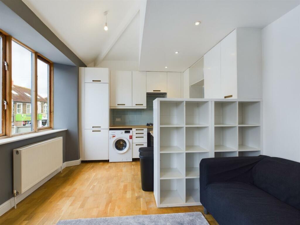 A bright and modern kitchenette with ample stor...