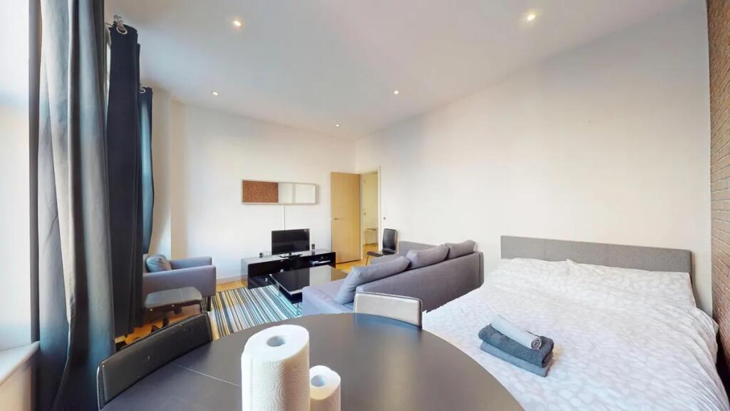 Bright and spacious master bedroom featuring a ...