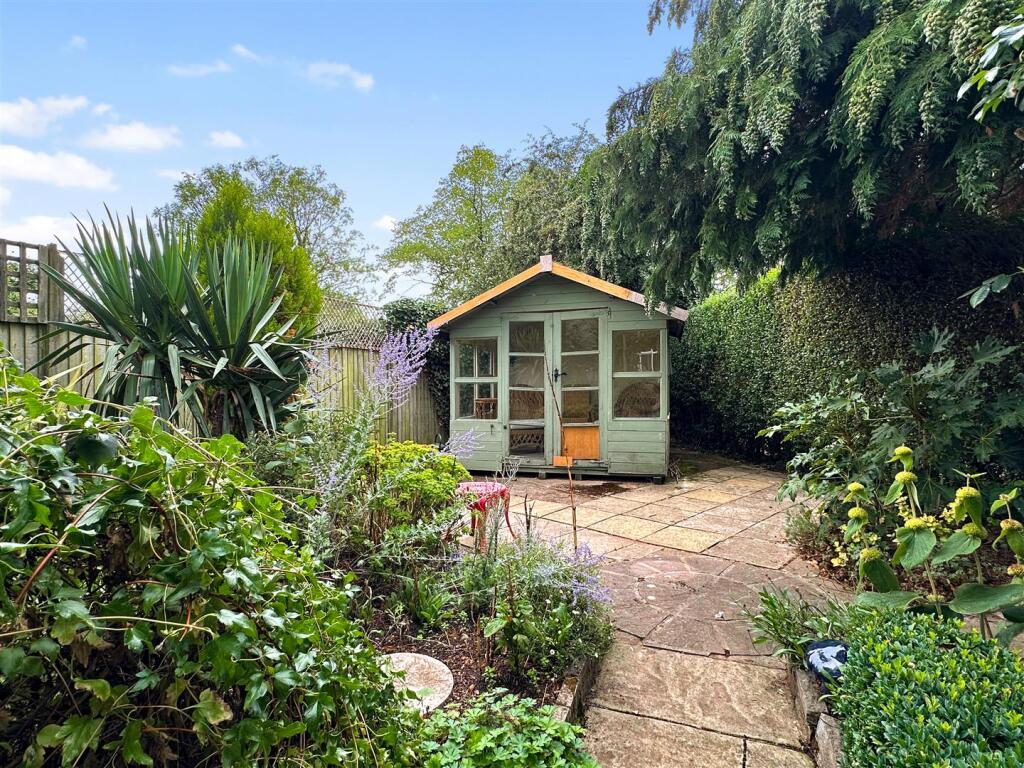 Secluded Garden With Extensive Paved Seating Area 