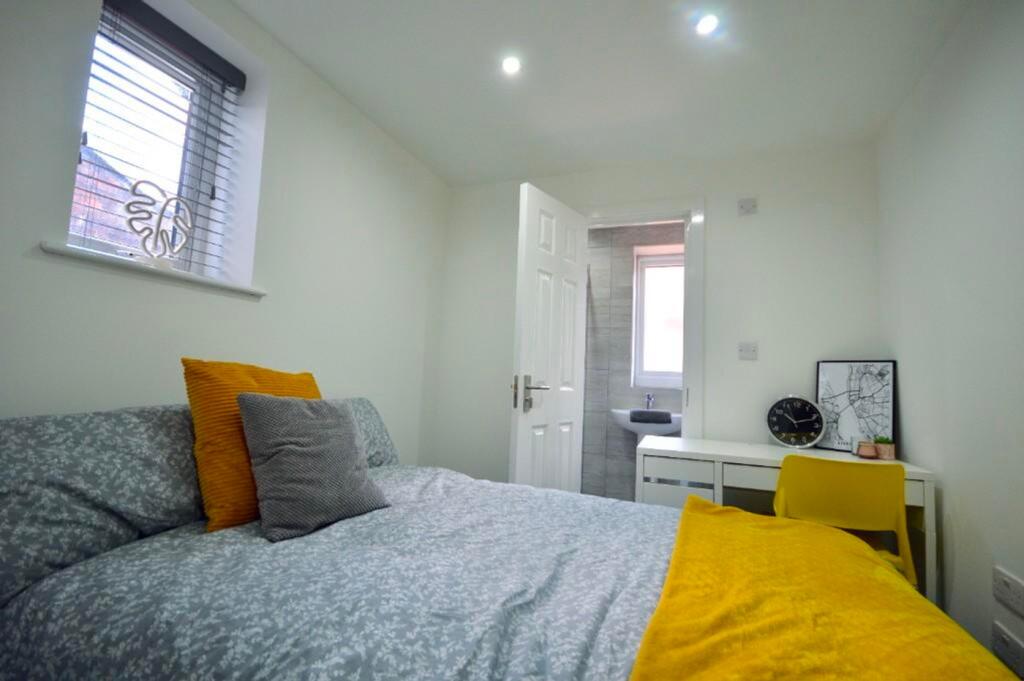 A bright and inviting double bedroom with moder...