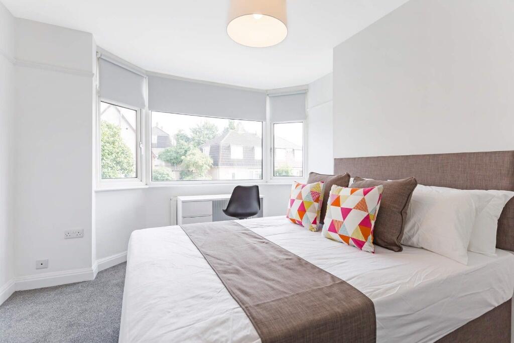 Bright and airy master bedroom featuring a larg...