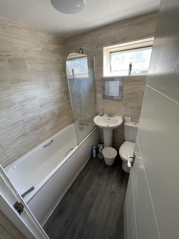 A modern bathroom suite featuring a clean white...