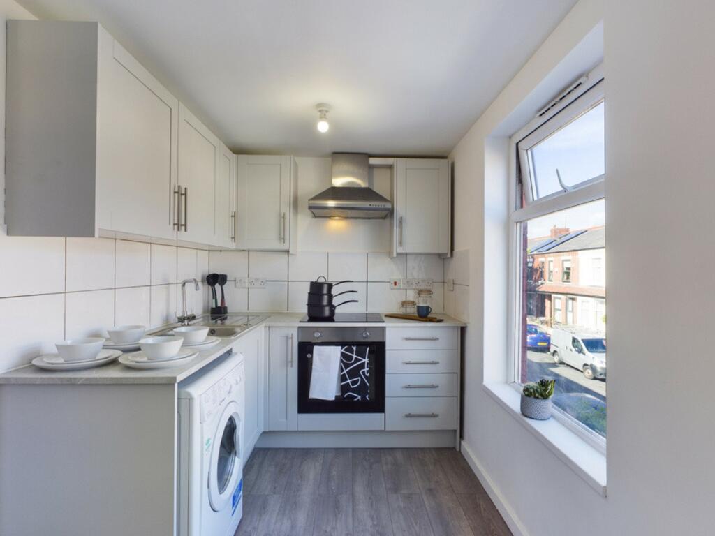 A bright and modern kitchen featuring ample cou...