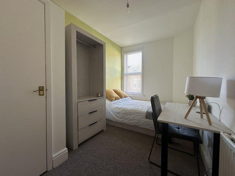 Cozy single bedroom featuring a comfortable bed...