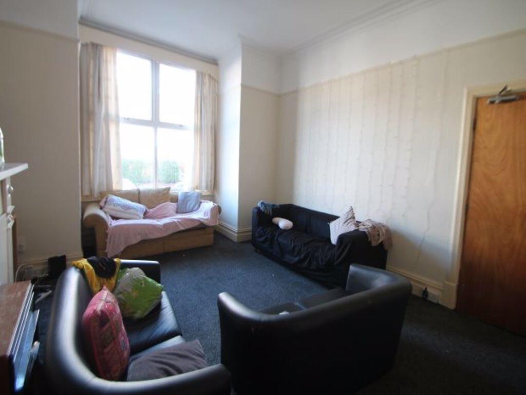 Bright and cozy living room featuring large win...