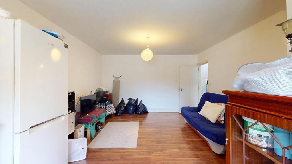 A neat and tidy living room featuring wooden fl...