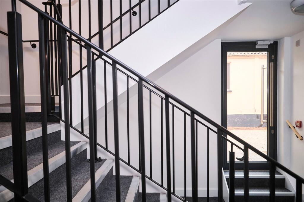 Bright and clean staircase area with sturdy bla...