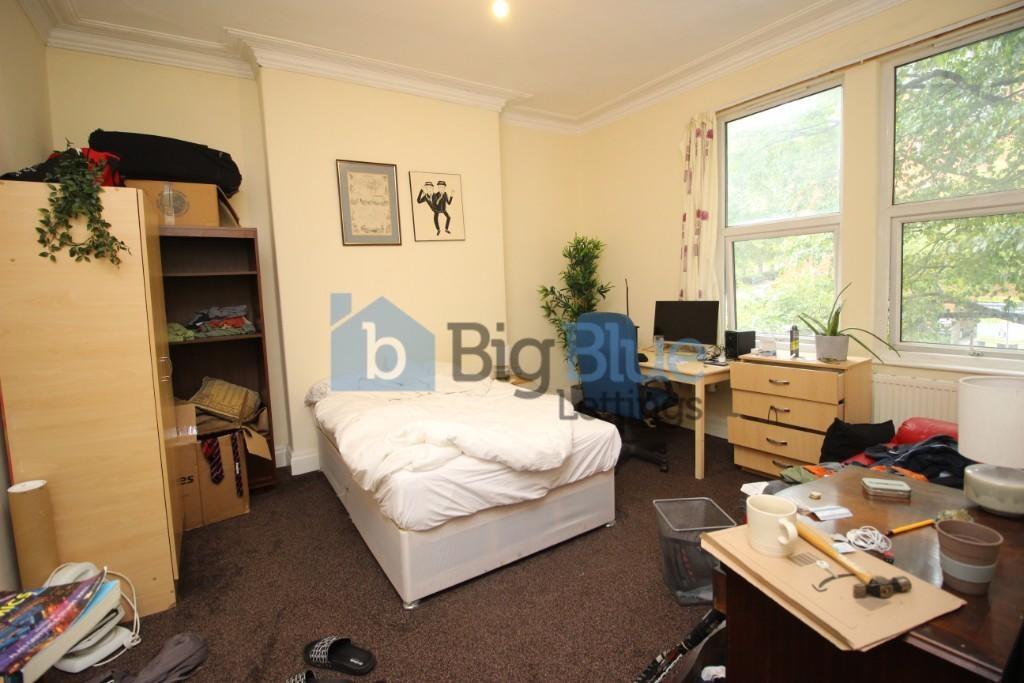 A cozy student bedroom featuring a single bed, ...