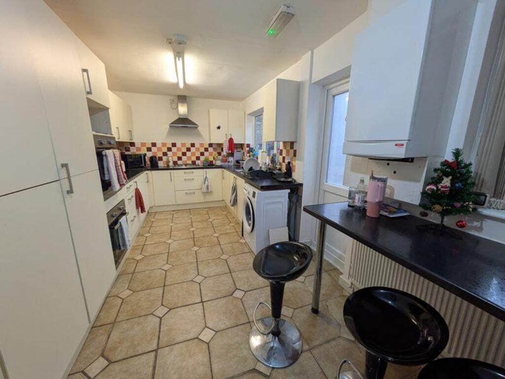 A spacious and clean kitchen featuring modern a...