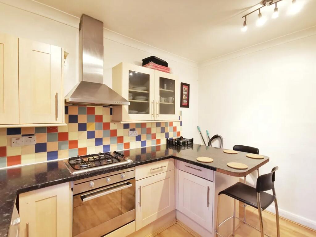 A bright and modern kitchen featuring a stylish...