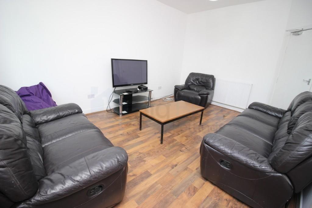 A contemporary living room featuring black leat...