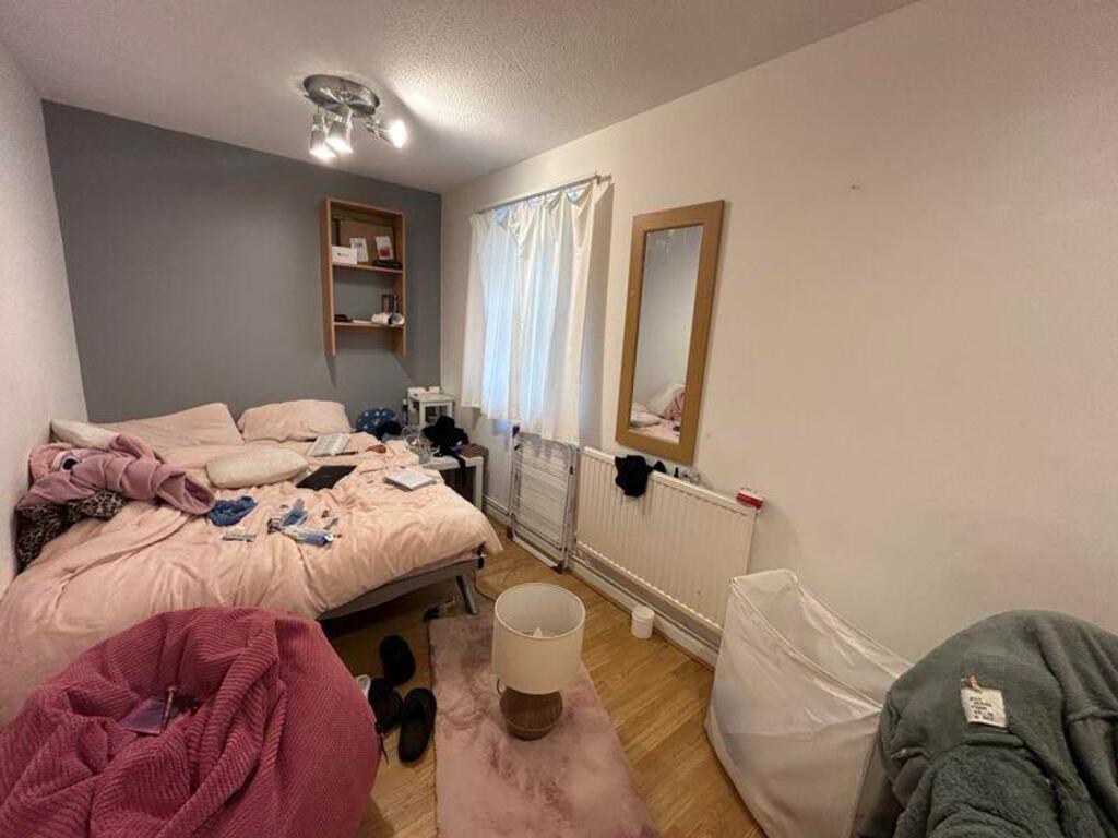 A cozy double bedroom with natural light and pe...