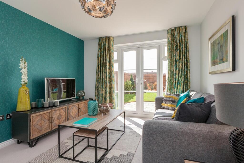The natural light from the French doors floods the living room