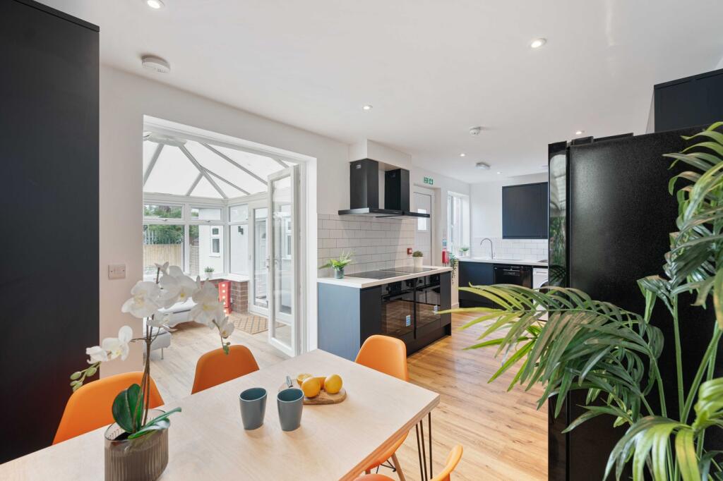 A bright and modern kitchen featuring sleek des...