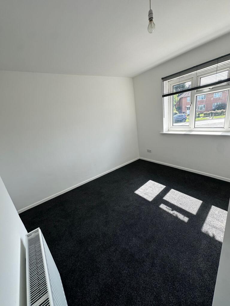 Bright double bedroom with fresh white walls an...