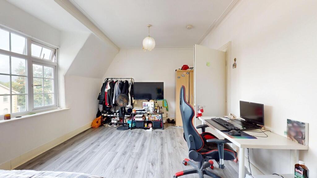 Bright and spacious living room with large wind...