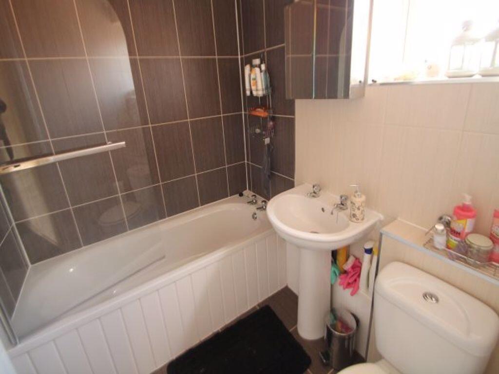 Bright and modern bathroom featuring a clean wh...