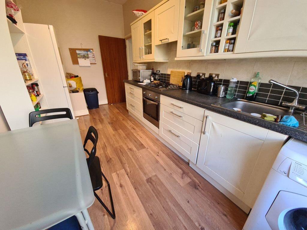 A well-maintained kitchen with ample storage ca...