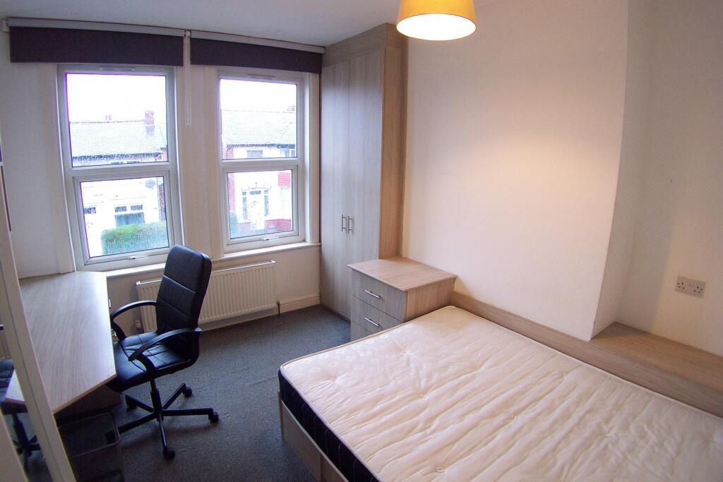 A cozy, well-maintained student bedroom featuri...